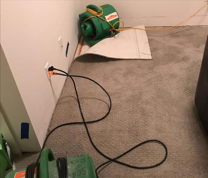 Air mover drying out carpets. 